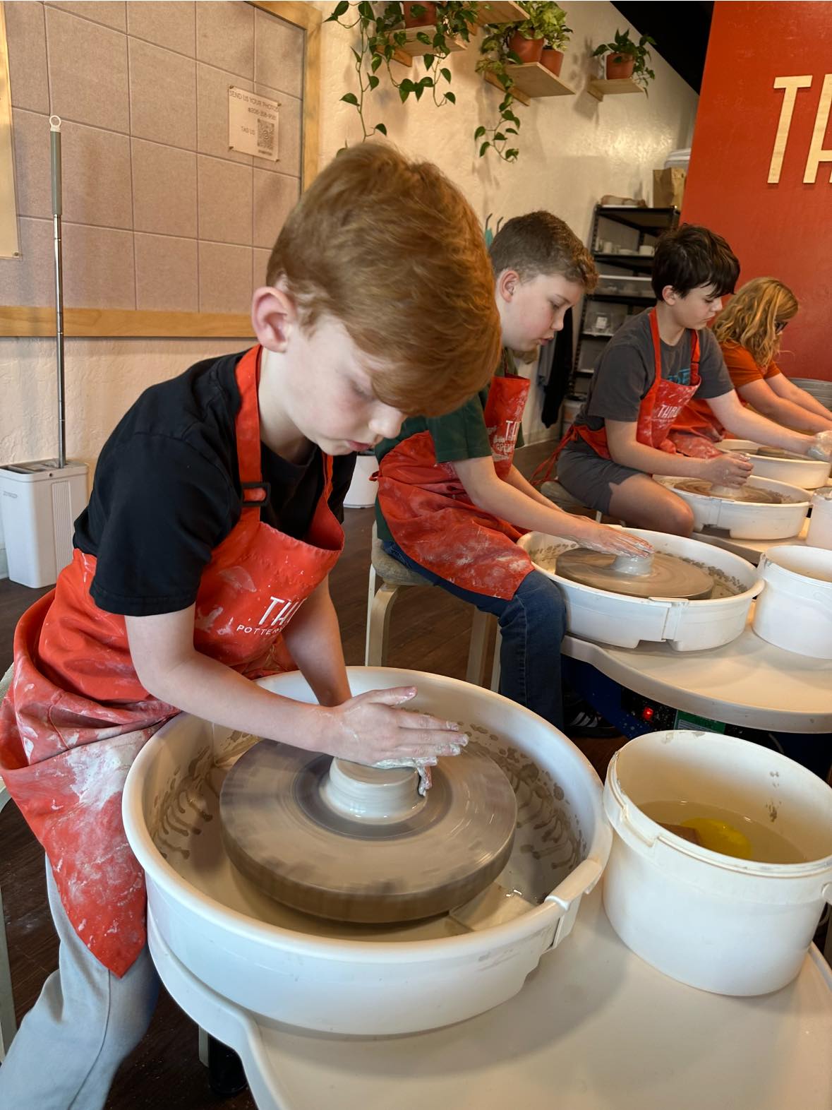 Students at pottery wheels