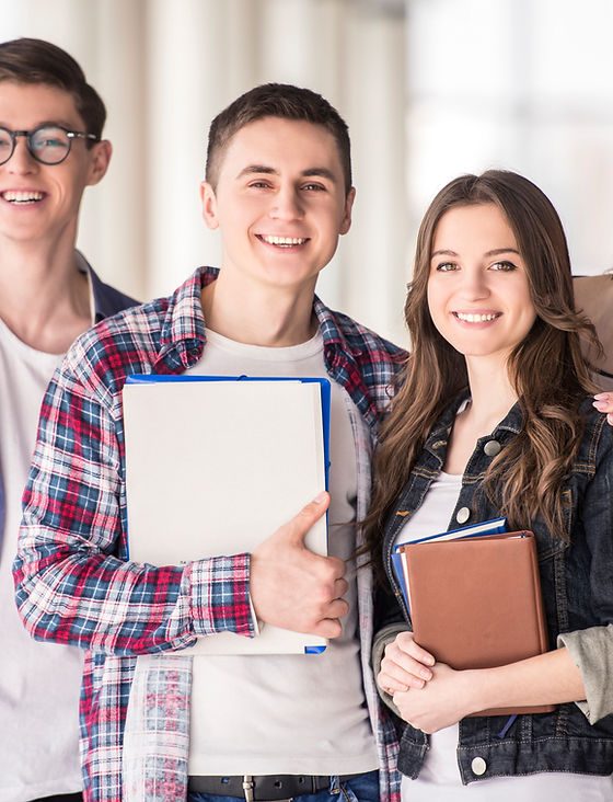 High school students smiling with textbooks and notebooks